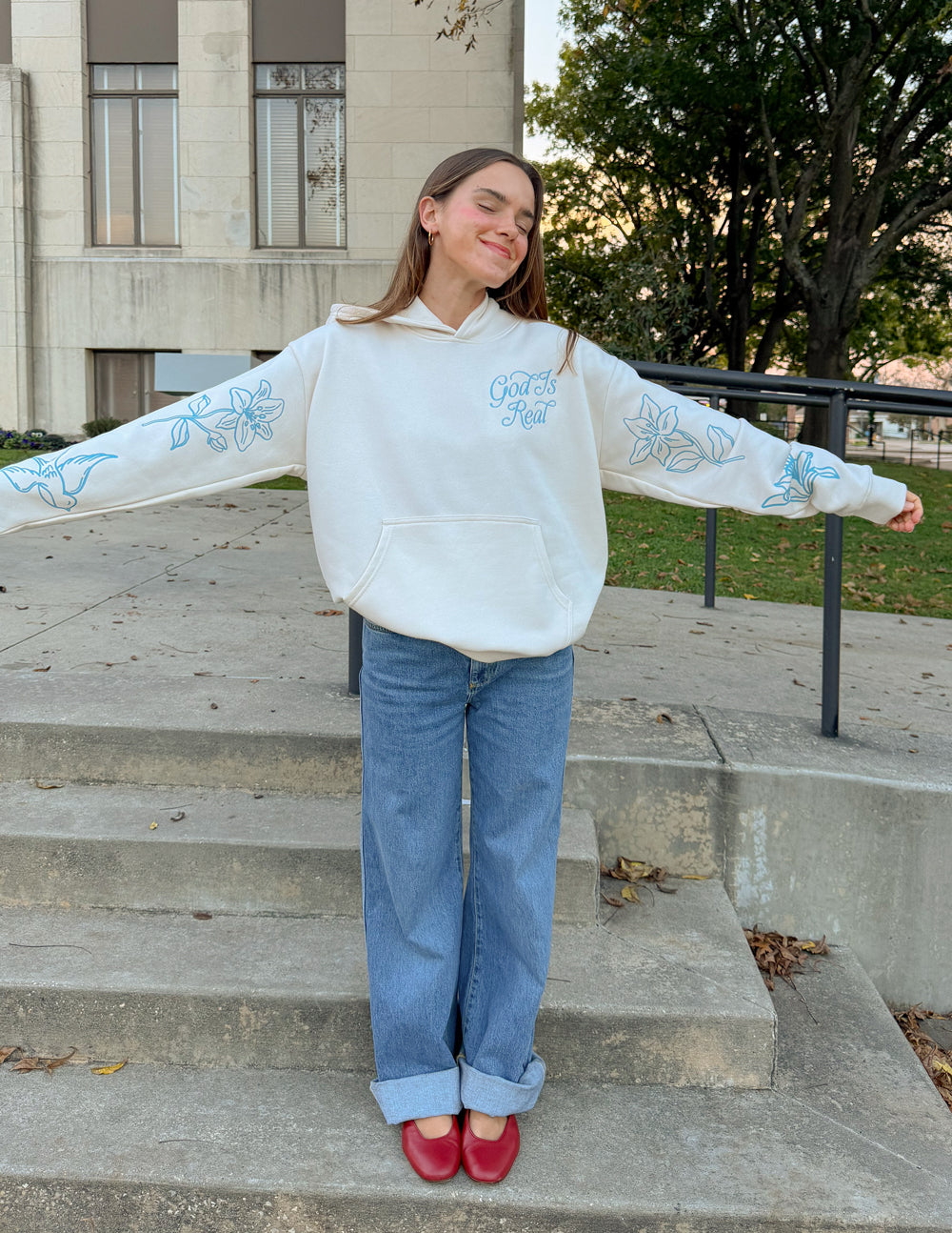 Unisex off-white hoodie with blue sleeve floral print, front pocket and hood