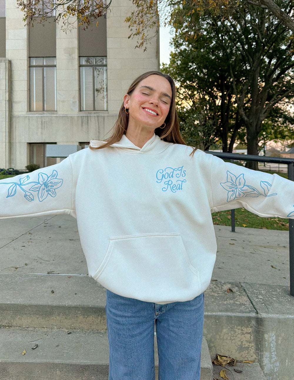 Unisex off-white hoodie with blue sleeve floral print, front pocket and hood