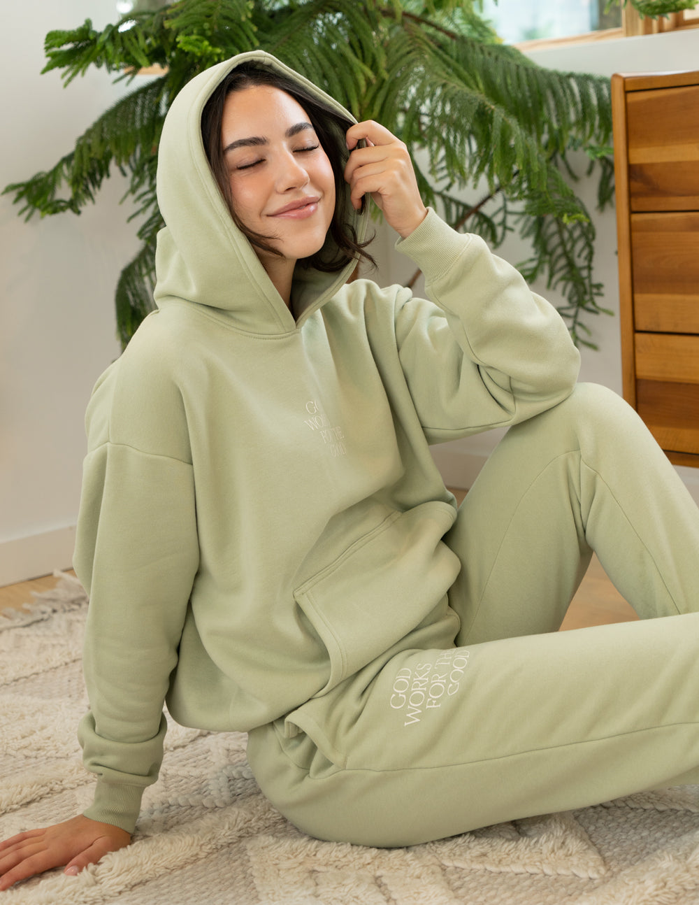 Light green unisex sweatpants worn with hoodie, side logo print