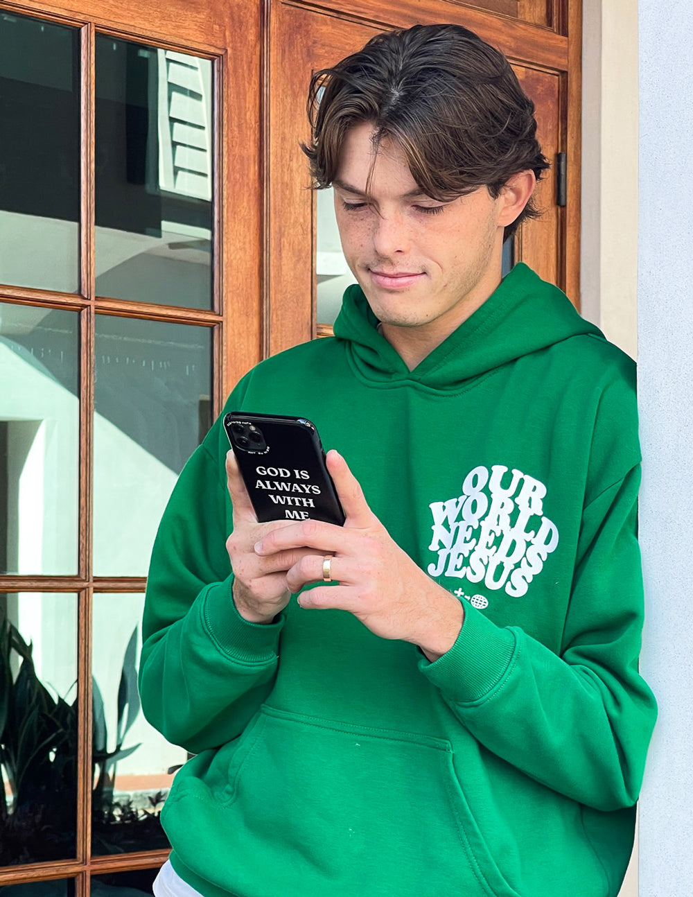 Black phone case with 'God is always with me' text, camera cutout visible.