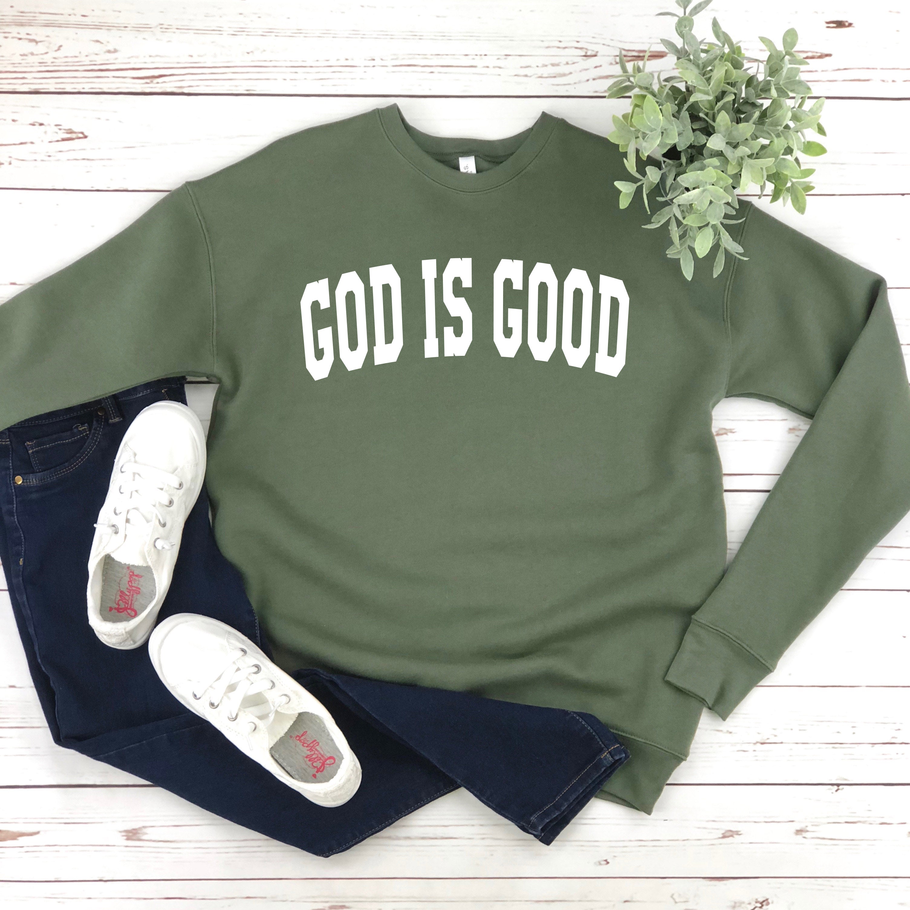 Unisex crewneck sweatshirt in military green with "GOD IS GOOD" front graphic