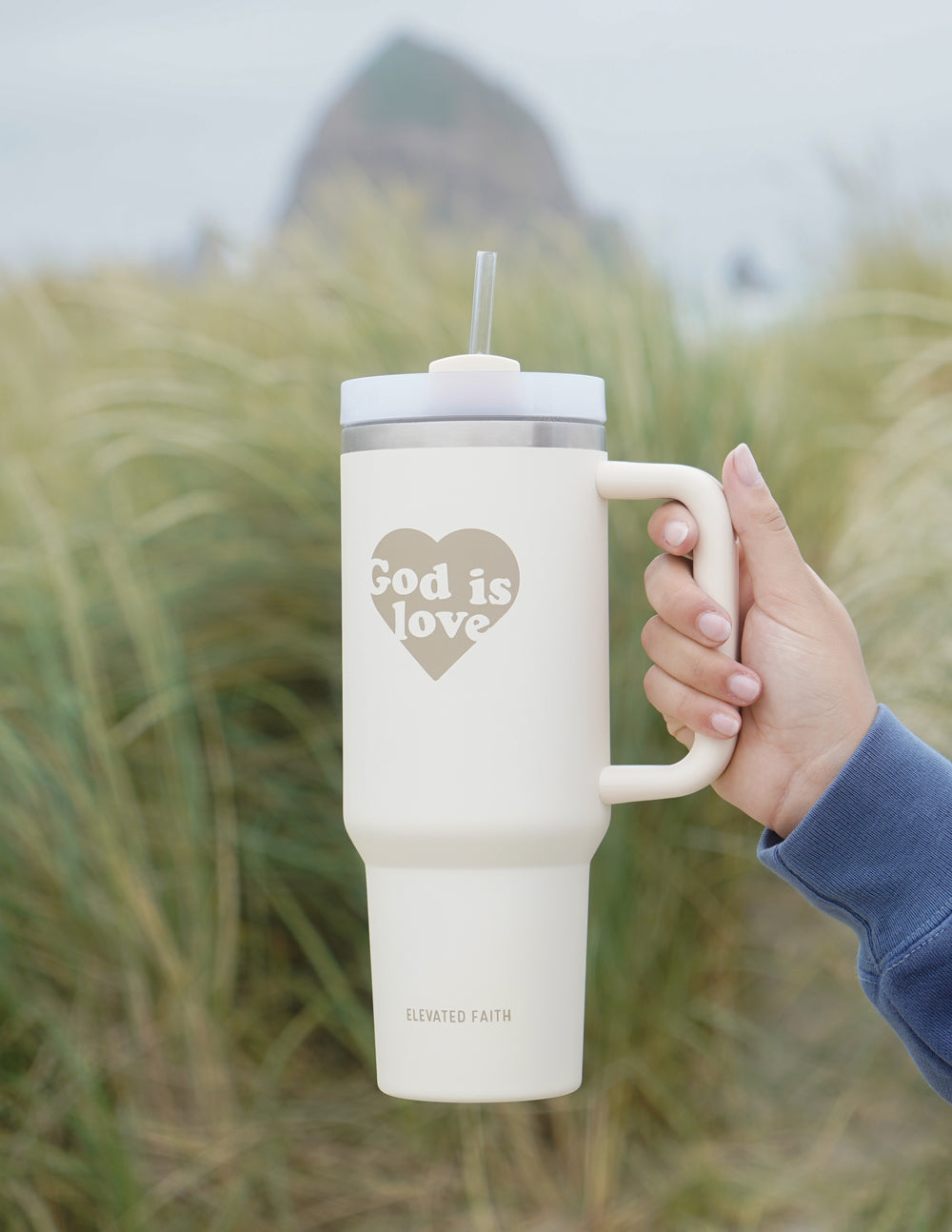40 oz tumbler with straw, cream body, "God is Love" heart graphic on front