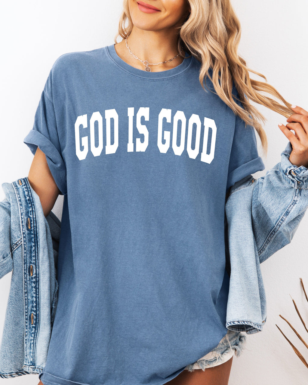 Blue jean garment-dyed crewneck T-shirt with “GOD IS GOOD” front lettering