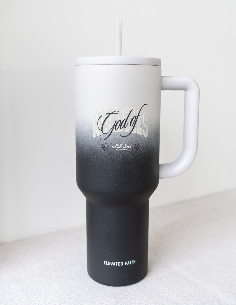40 oz tumbler with straw, side handle, white-to-black gradient; God of on front
