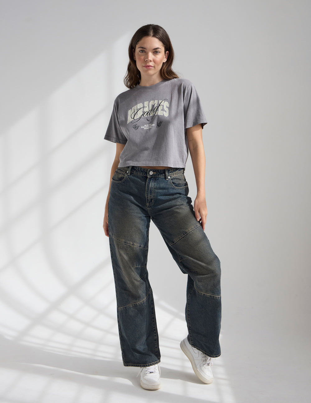Cropped gray women’s tee with “Miracles” logo on the front