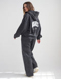 Dark charcoal full-zip hoodie with back wordmark and logo patch, hood up