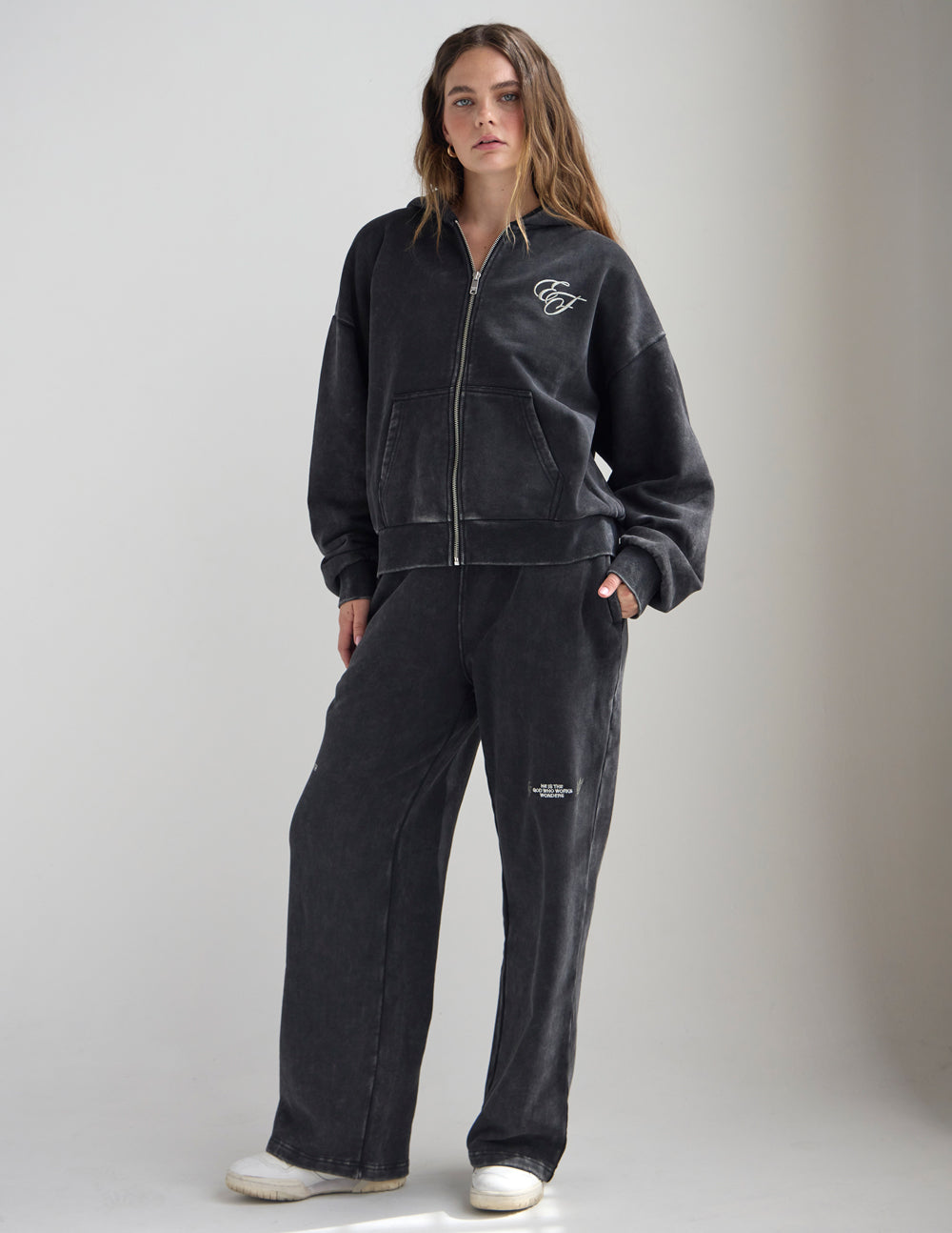 Dark charcoal full-zip hoodie with front zipper, hood, and small chest logo