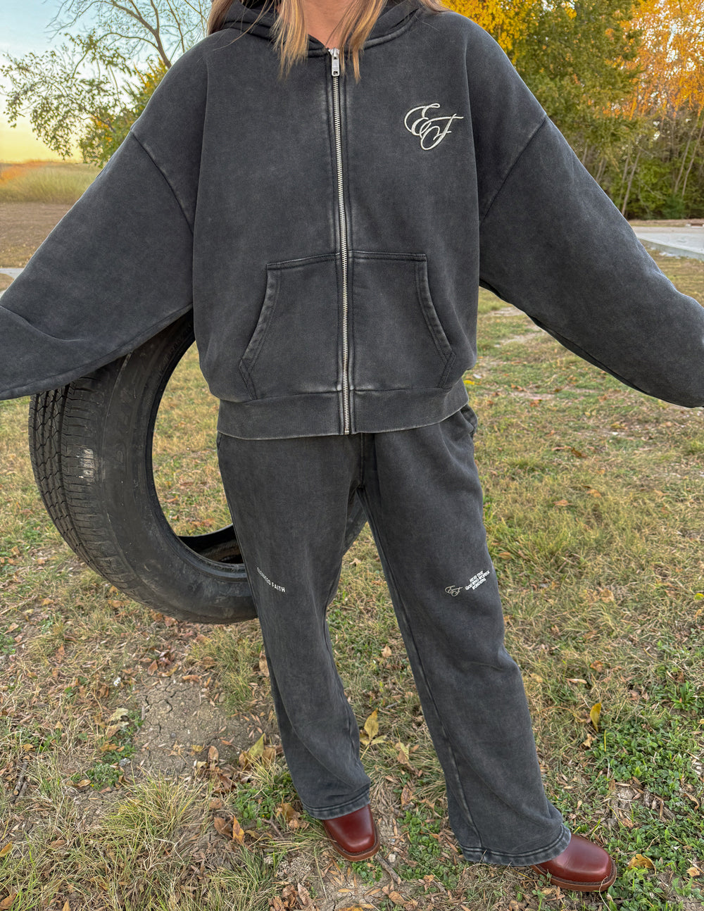 Charcoal zip-up hoodie with chest logo and front kangaroo pockets
