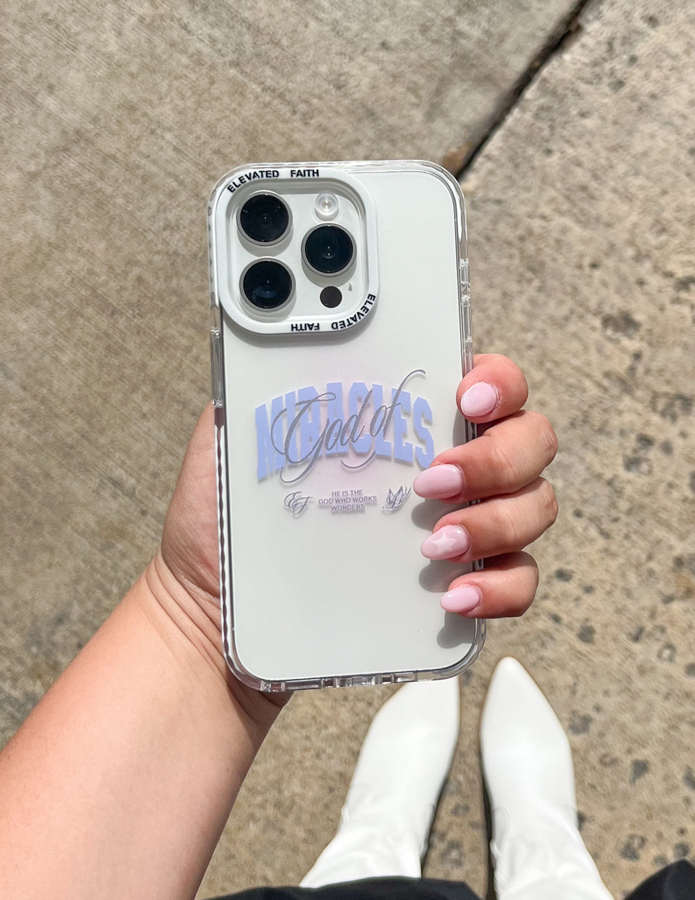 White phone case with blue “Miracles” script and clear bumper with camera cutouts
