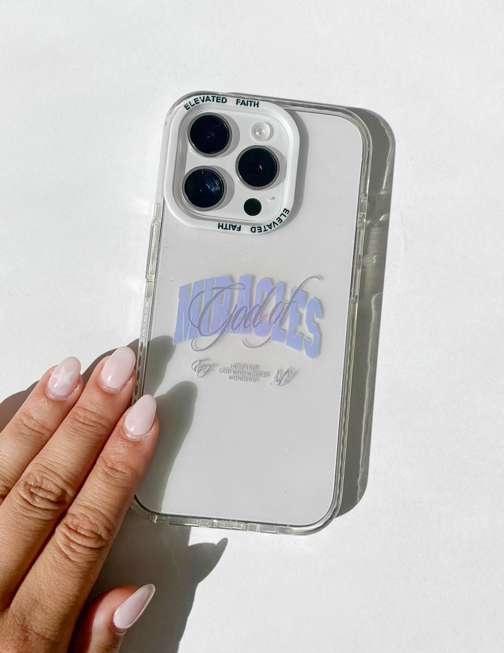 White phone case with “Miracles” script and transparent clear frame