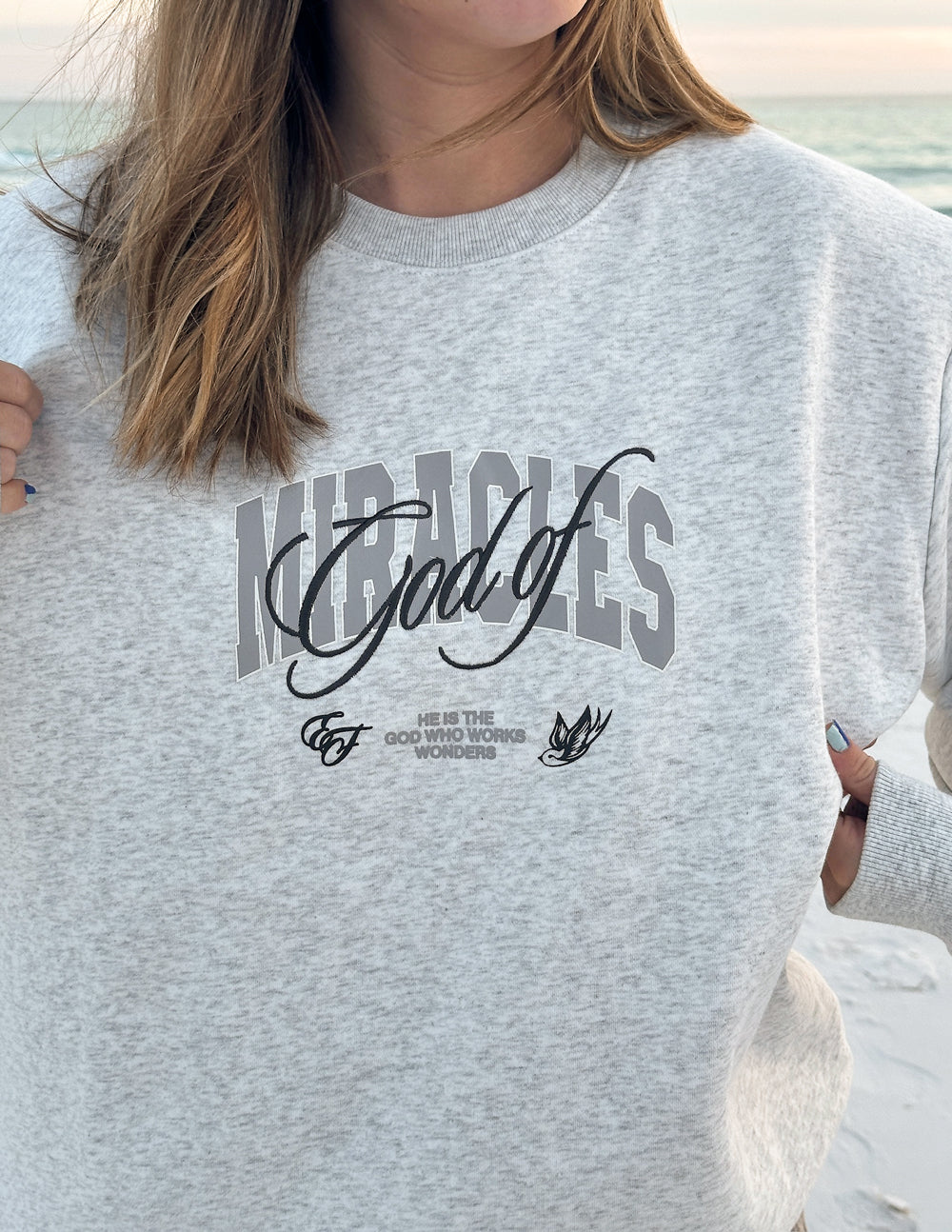 Heather gray unisex crewneck sweatshirt with large front graphic logo.