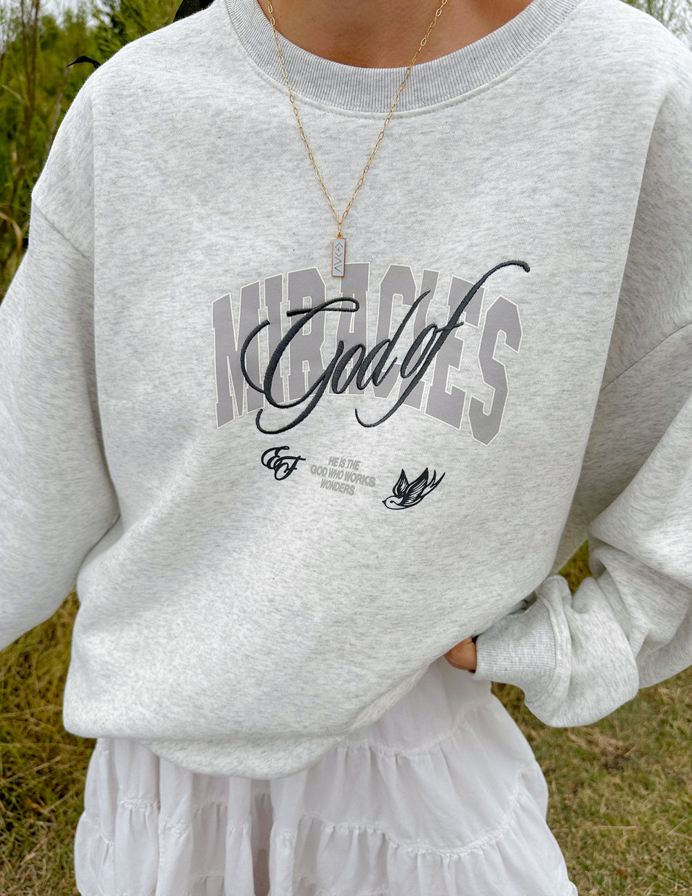 Heather gray unisex crewneck sweatshirt close-up with front graphic logo.