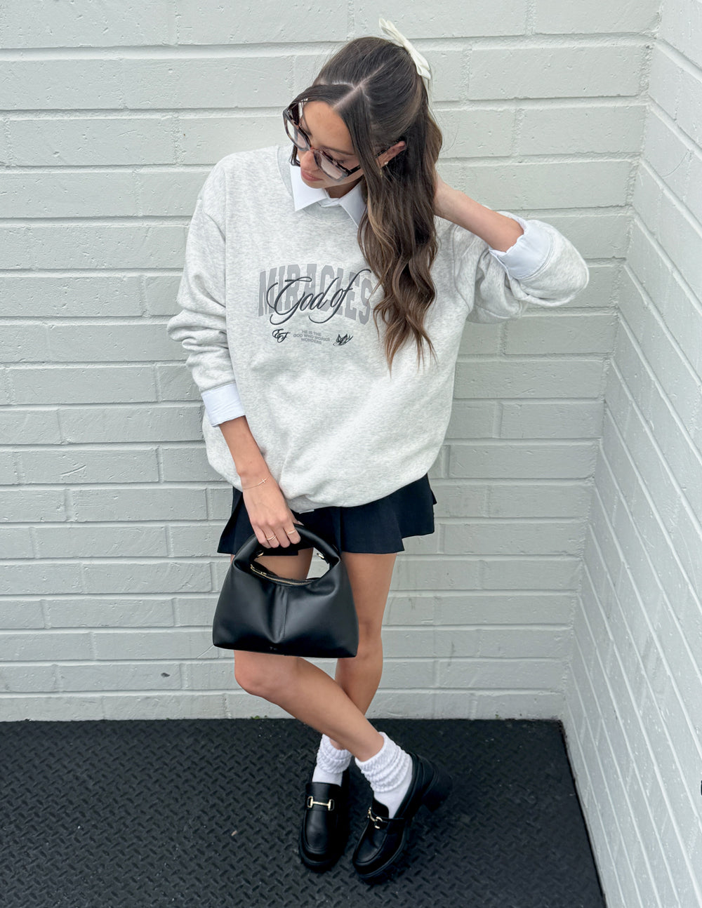 Heather gray unisex crewneck sweatshirt with front graphic and long sleeves.