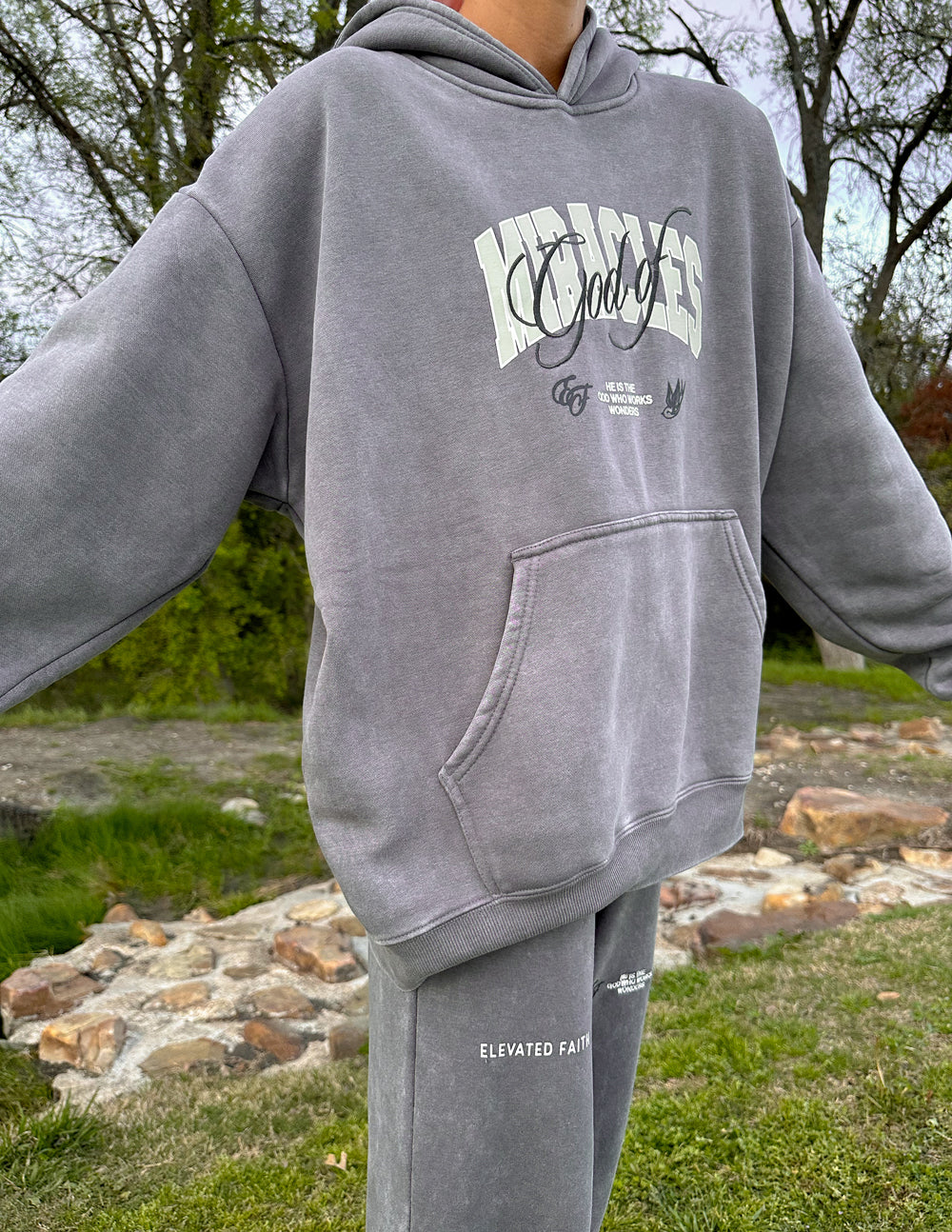 Grey hoodie with front script logo, kangaroo pocket, and hooded neckline