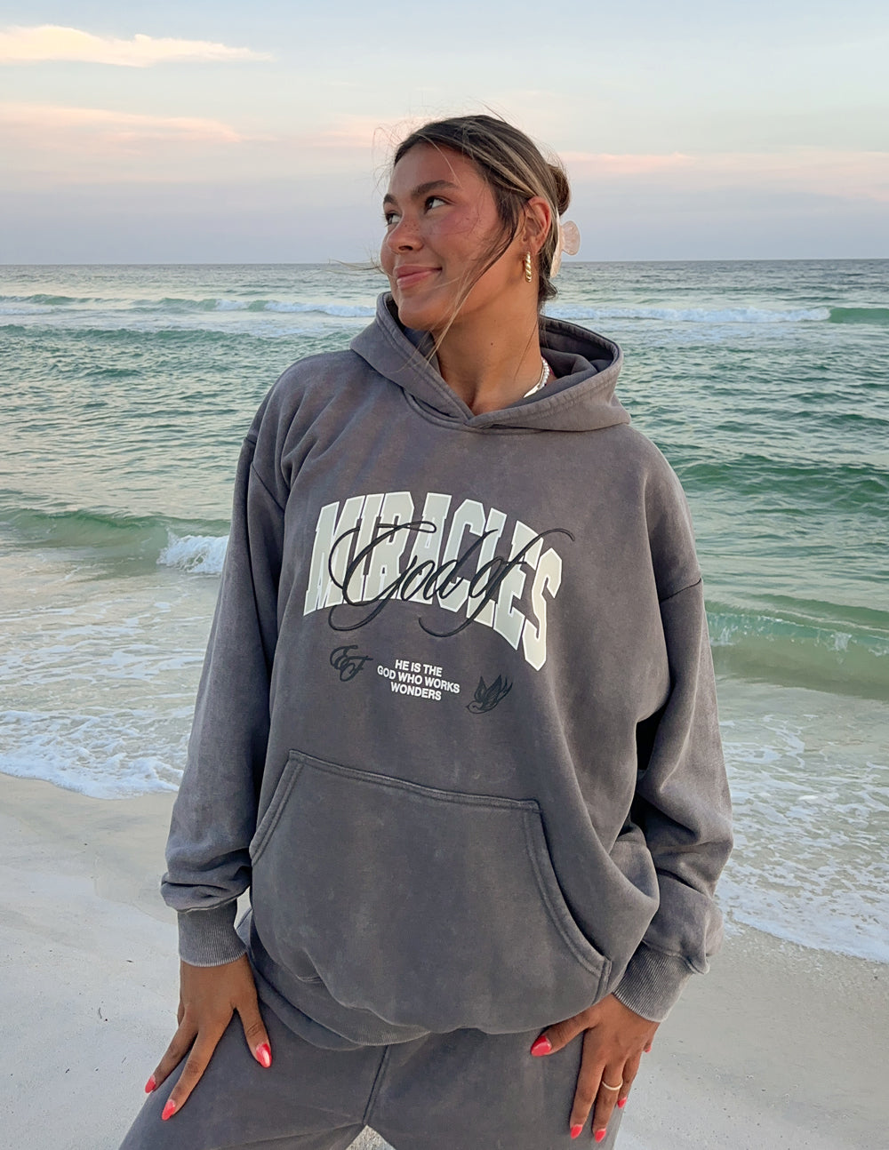 Grey unisex hoodie with front kangaroo pocket and script logo graphic