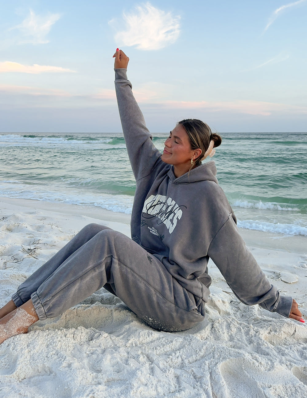 Grey unisex hoodie with hood up, front kangaroo pocket and script logo