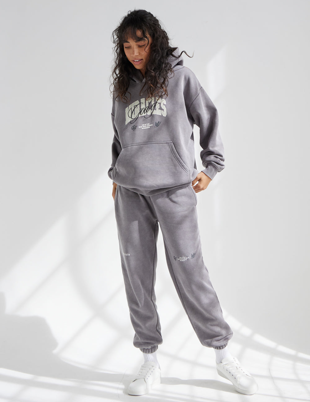Dark gray unisex sweatpants, relaxed fit, elastic cuffs, small logo on leg