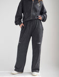 Charcoal wide-leg sweatpants with elastic waistband and embroidered thigh graphic