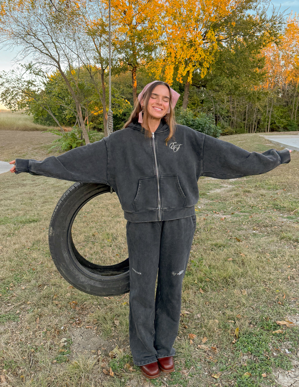 Charcoal wide-leg sweatpants worn with hoodie, elastic waistband and side logos