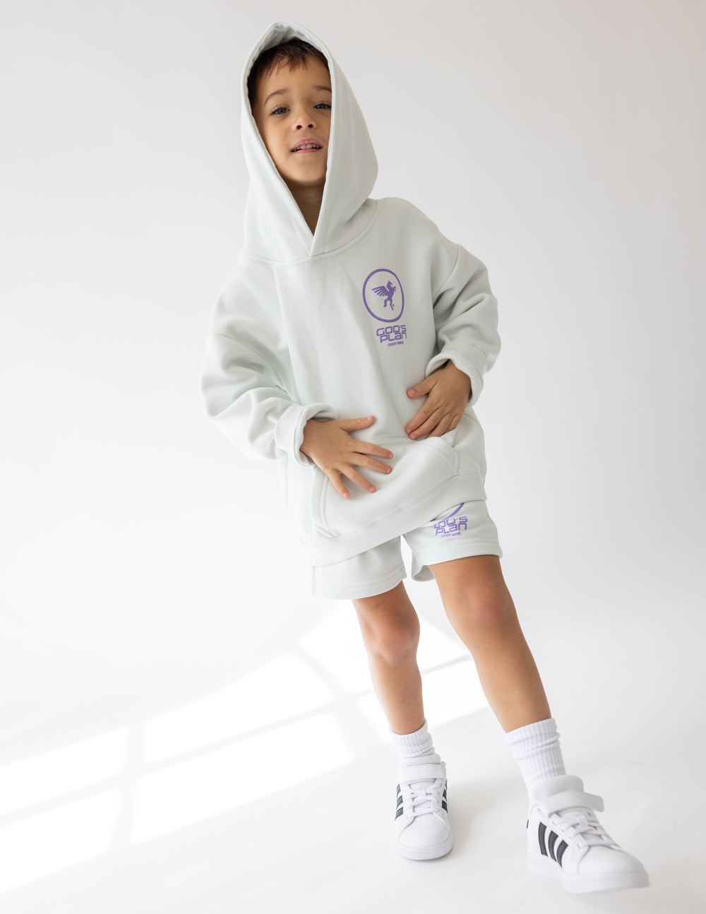 Kids light gray racing hoodie with purple logo on chest and kangaroo pocket