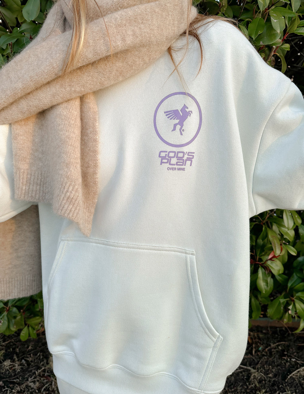 White hoodie with purple circular logo on chest and front pocket
