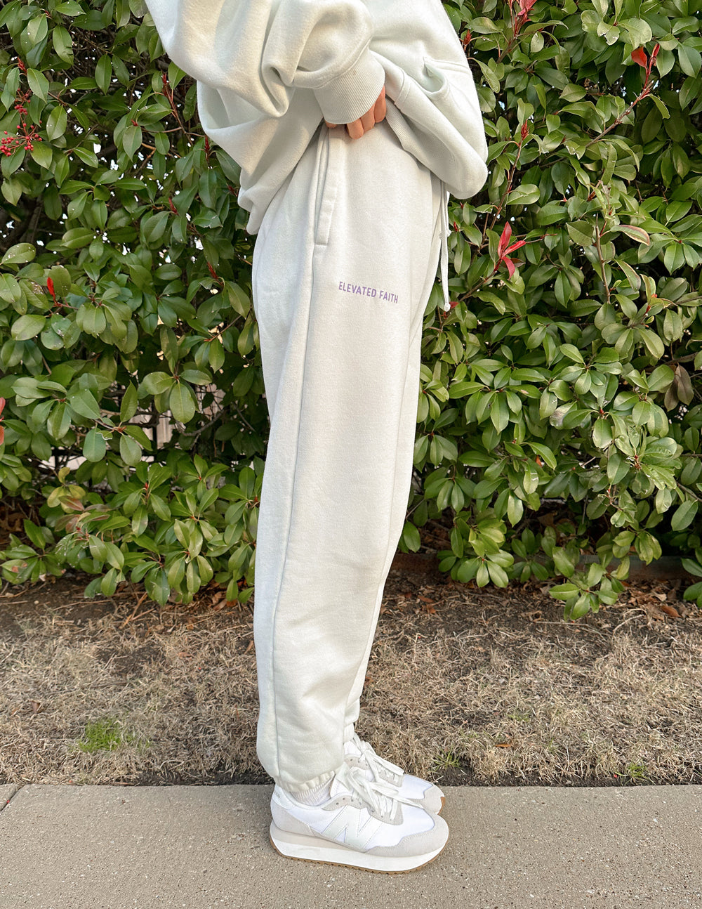 Light cream unisex sweatpants with small back logo print and tapered ankle cuffs
