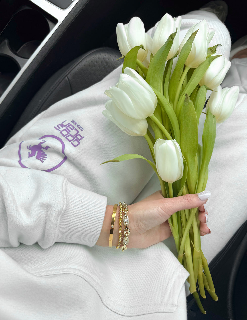 Light cream sweatpants with purple logo patch on thigh and elastic waistband