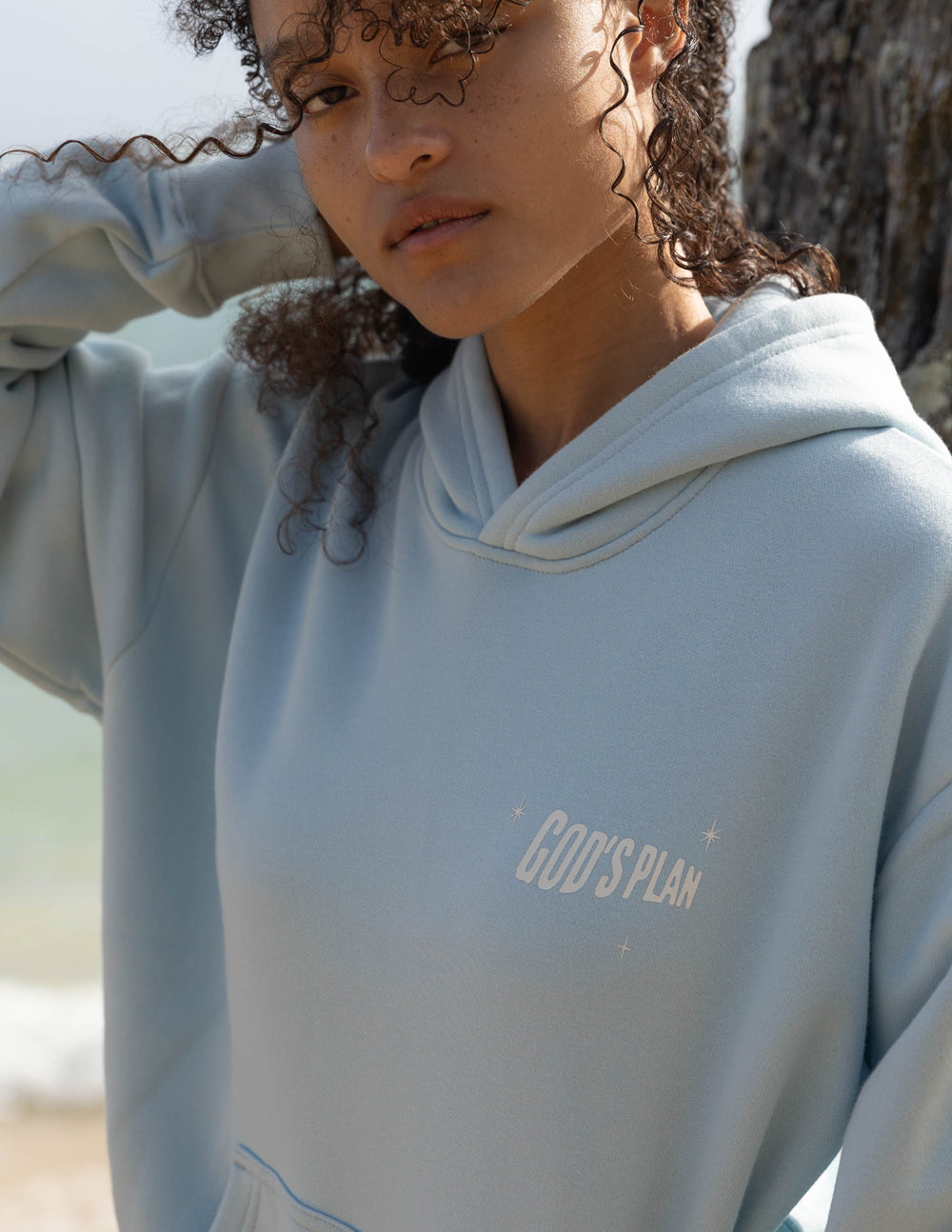 Light blue unisex hoodie with chest graphic and hood with drawstrings