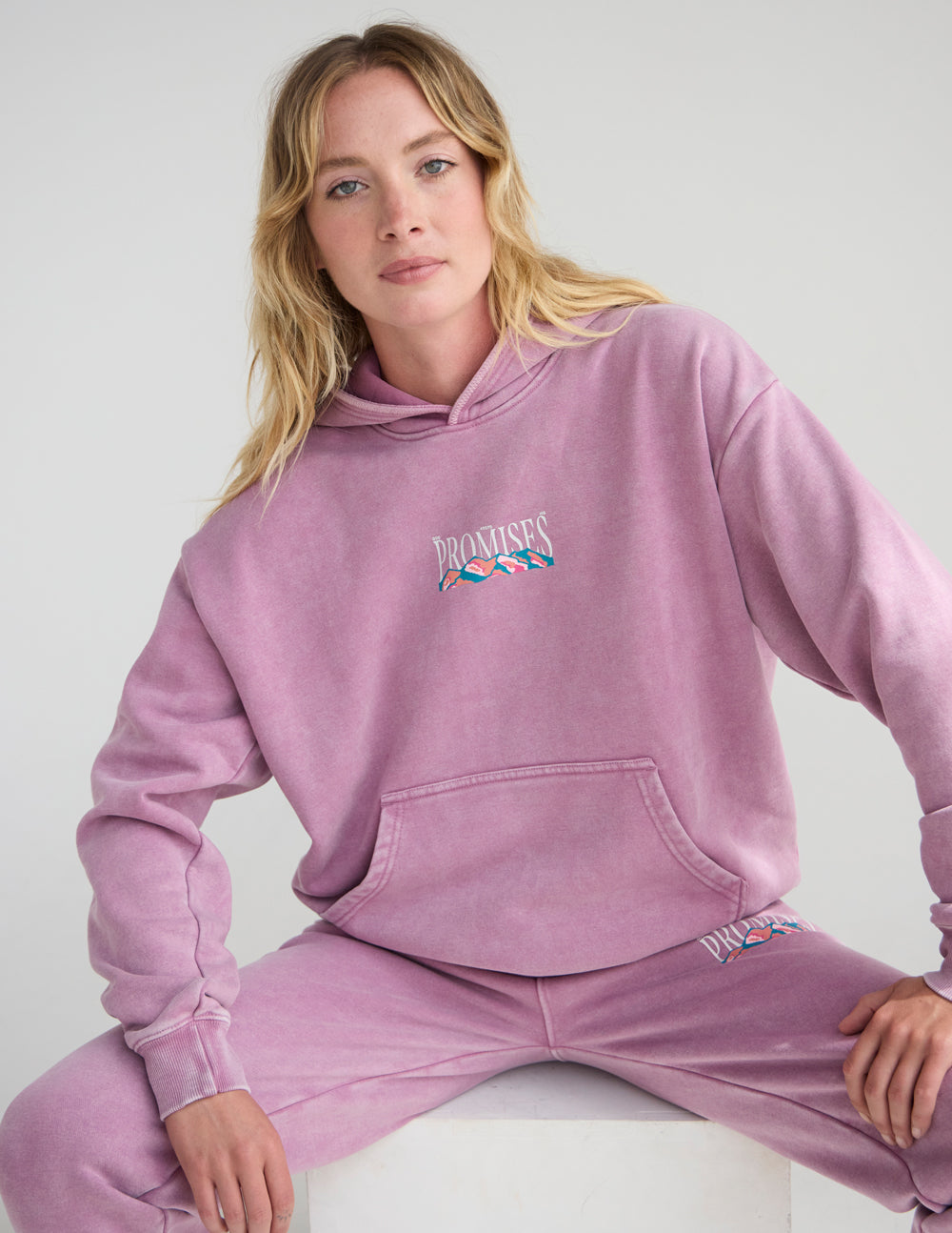 Lavender unisex hoodie with front pocket and small “Promises” chest graphic