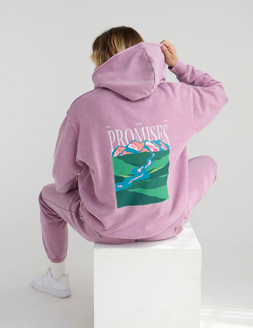 Lavender unisex hoodie back view with hood and “Promises” landscape graphic