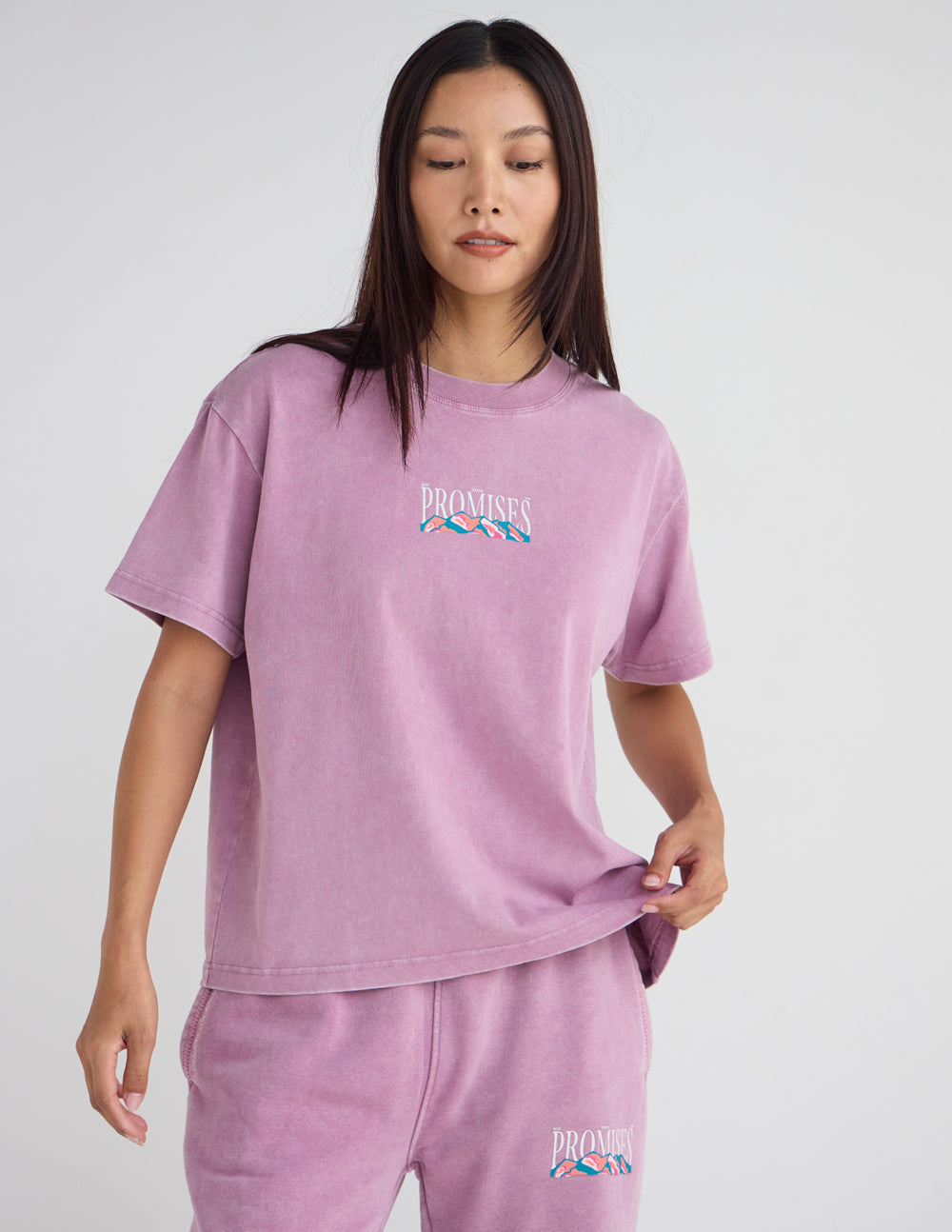 Lavender unisex T-shirt with small chest “Promises” logo and landscape graphic.