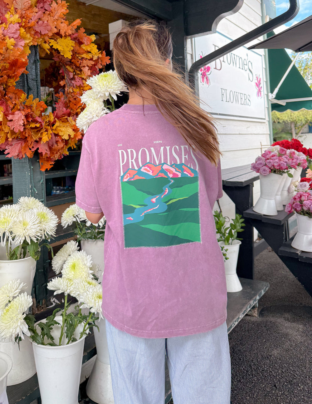 Lavender unisex T-shirt, back print with “Promises” text over multicolor landscape.