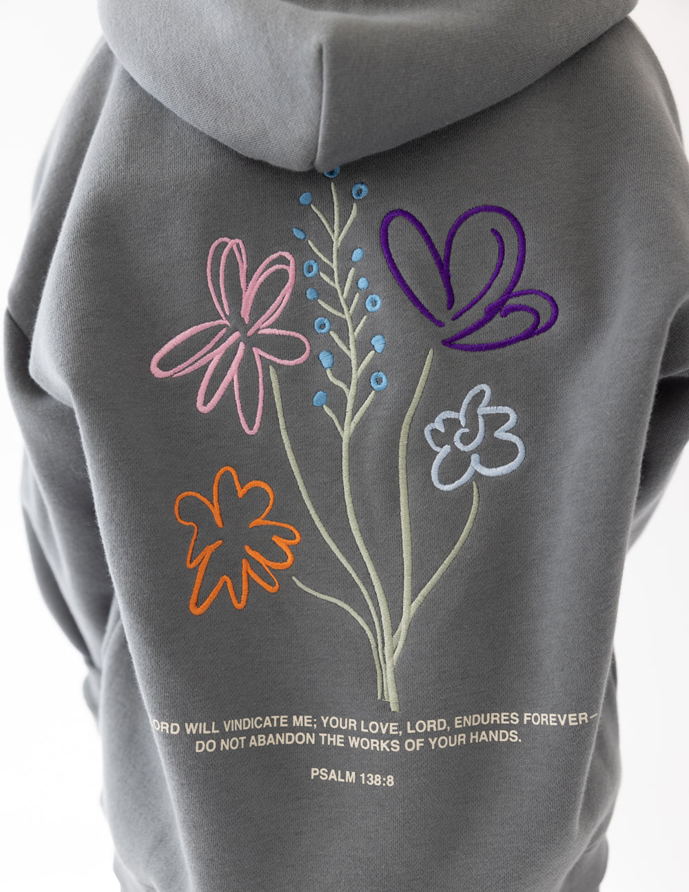 Gray hoodie back with colorful flower embroidery and small verse text