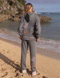 Gray unisex hoodie with colorful floral graphic on the back and hood.