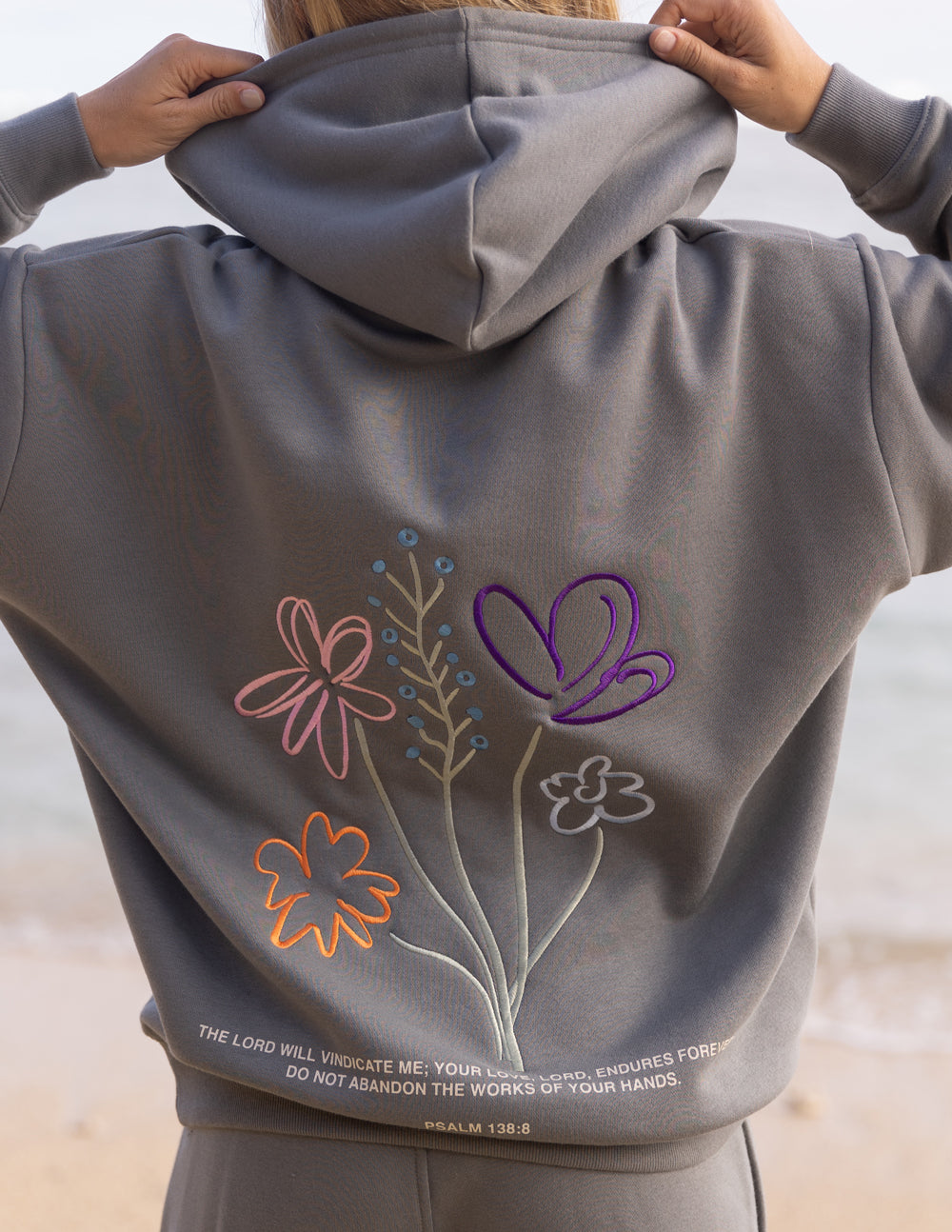 Gray unisex hoodie back with colorful floral and heart graphic under the hood.