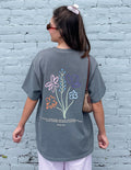 Unisex heather-gray tee with back floral graphic, short sleeves and relaxed fit