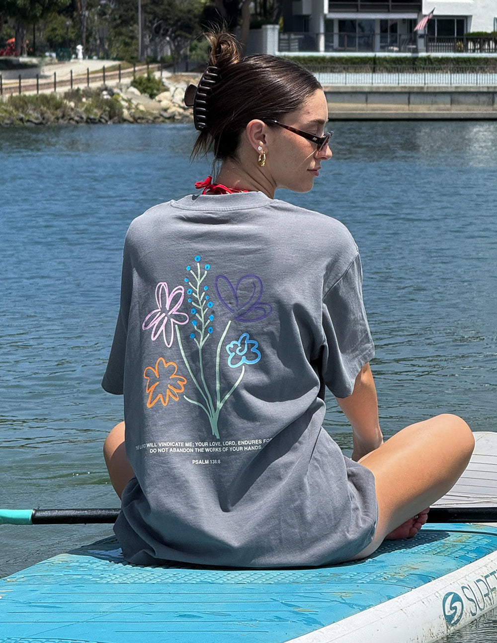 Unisex heather-gray graphic tee, back floral text design in pink, blue, and orange