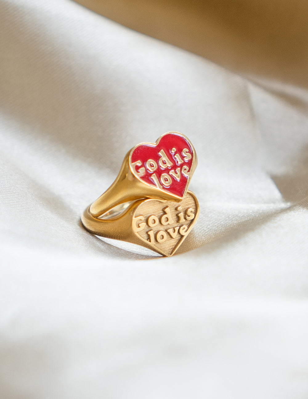 Gold-tone enamel signet ring with red heart inset reading “God is Love”