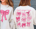 Cream sweatshirt with large pink bow graphic and “God says I am” text