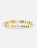 Gold beaded cross bracelet with a small white cross charm and link accents