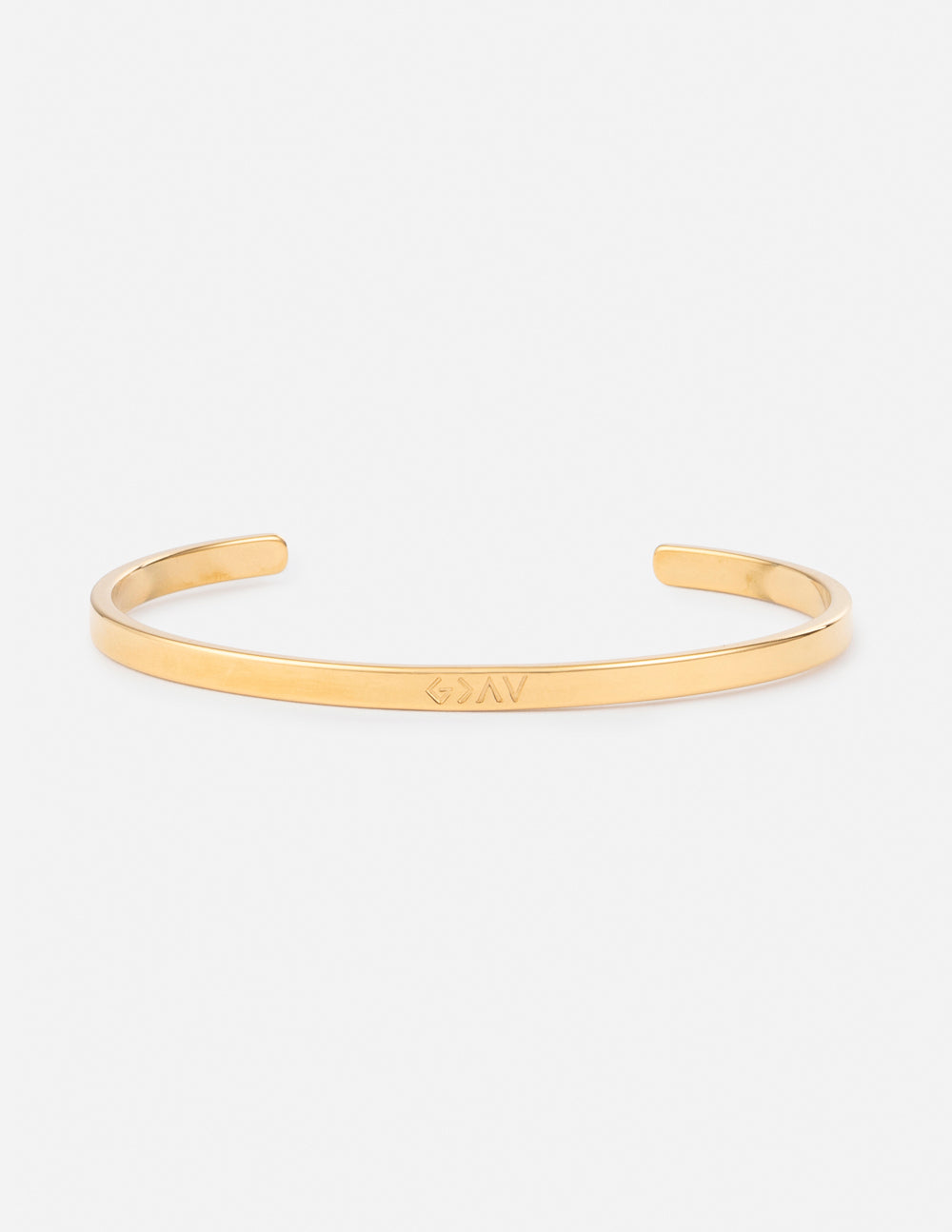 Gold cuff bracelet with engraved linear lettering detail