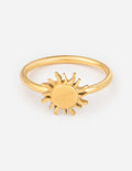 Gold sunburst ring with raised sun charm on a slim band