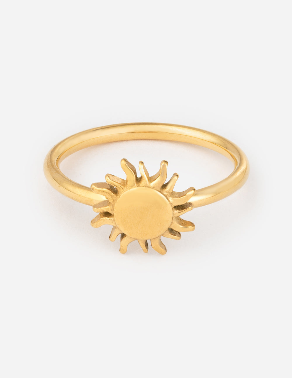 Gold sunburst ring with raised sun charm on a slim band