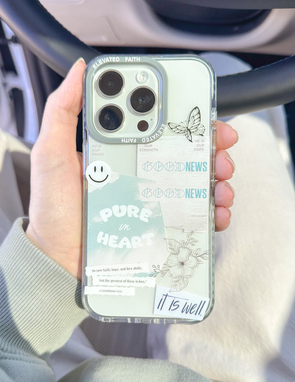 Transparent phone case with light blue border, butterfly and faith message on clear panel