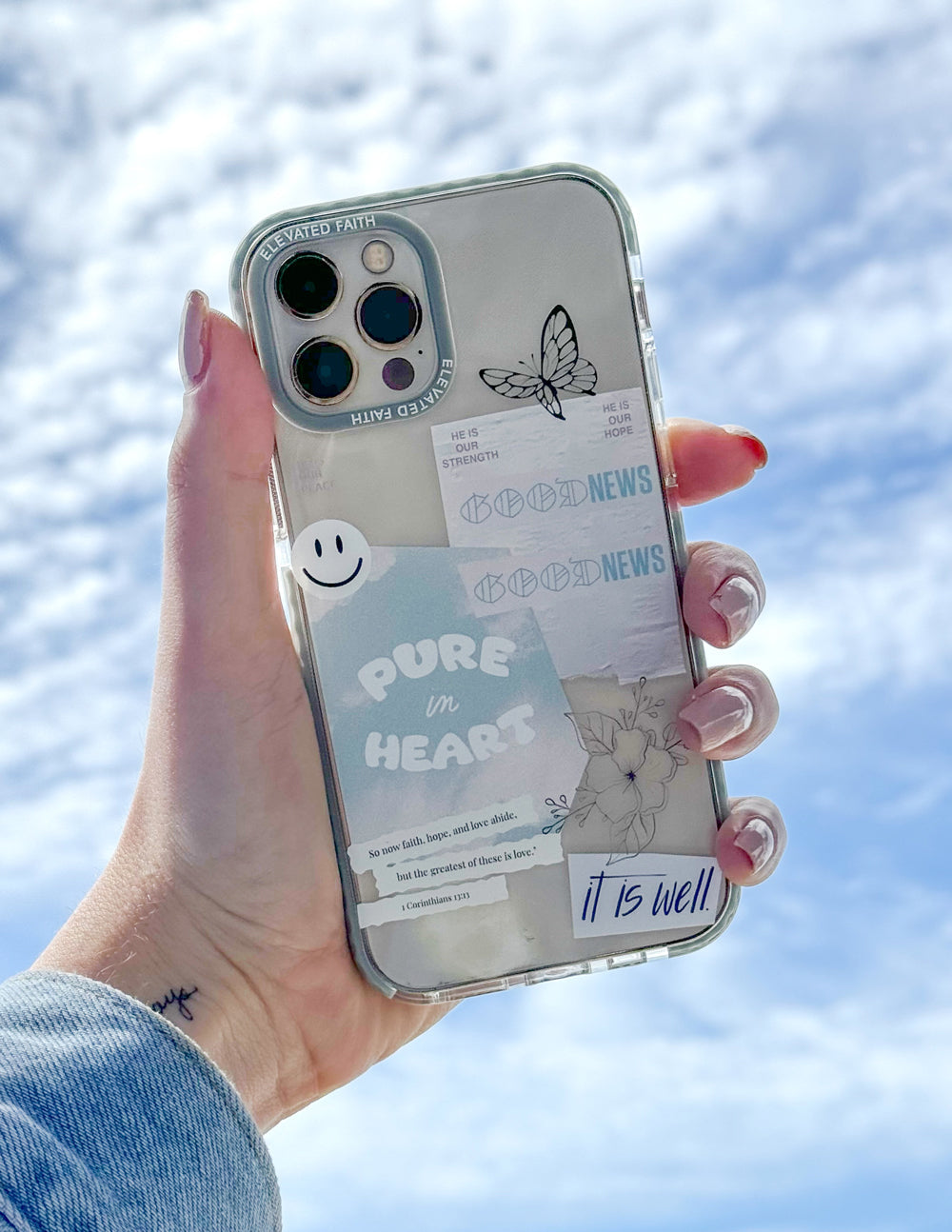 Transparent phone case with light blue border, butterfly and 'PURE in HEART' lettering