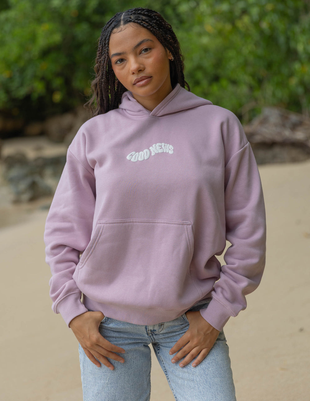 Dusty pink unisex hoodie with small chest logo and hood