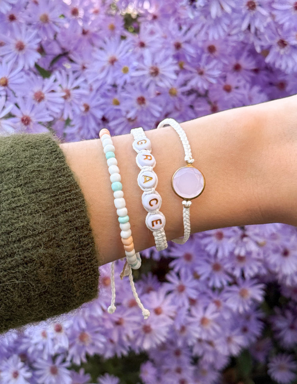 Grace bracelet pack: bracelets on wrist with pastel beads and oval purple charm