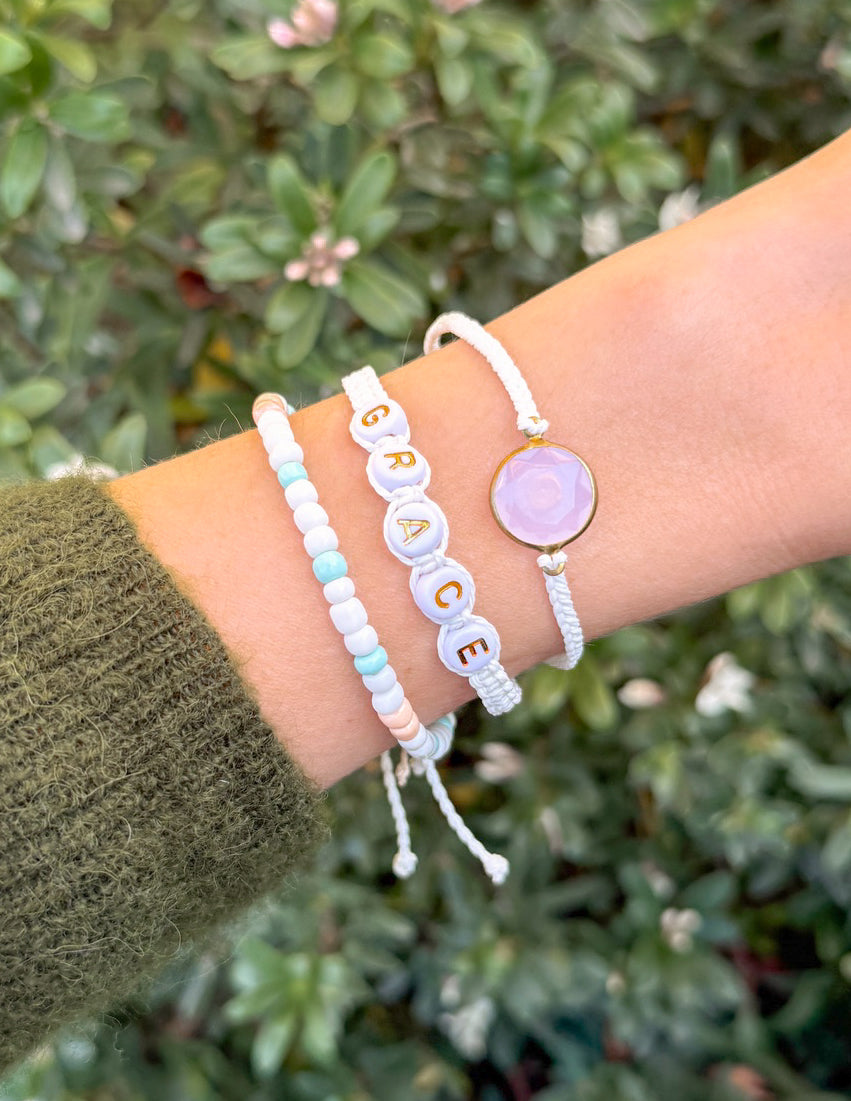 Grace bracelet pack: wrist bracelets with white cord, beads, and oval purple charm