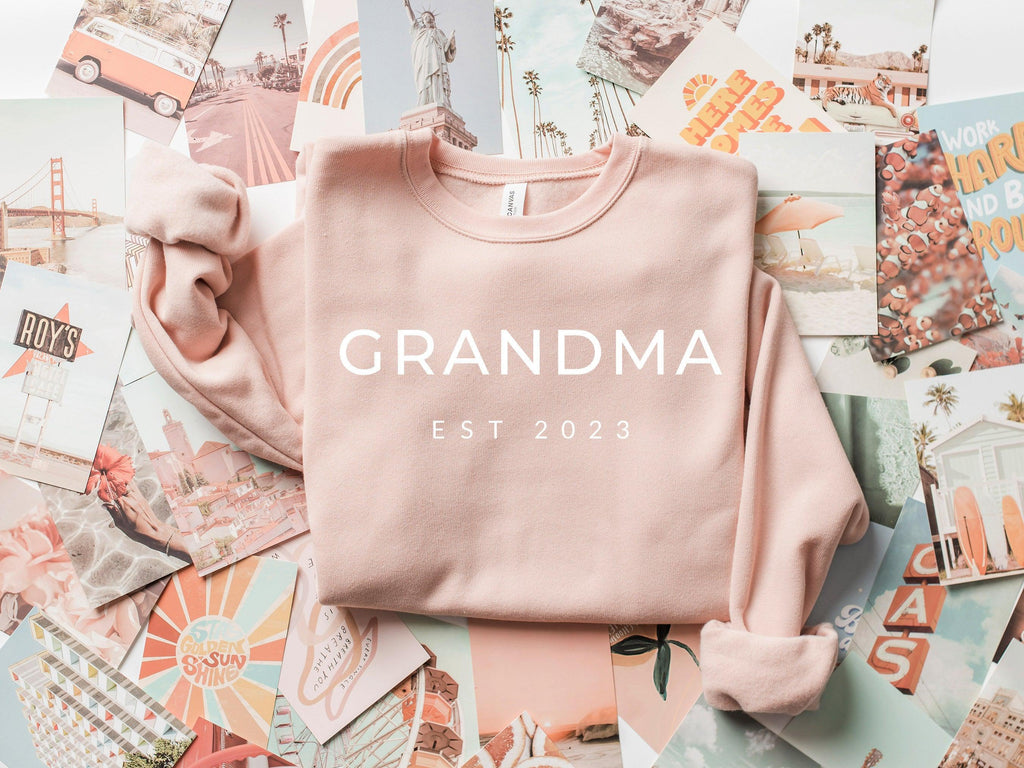 Light pink sponge fleece sweatshirt with 'GRANDMA EST 2023' front print