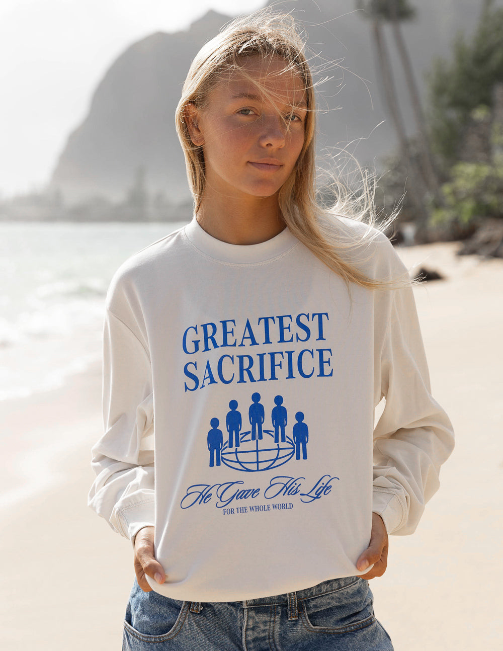 White long-sleeve unisex T-shirt with blue “Greatest Sacrifice” graphic front